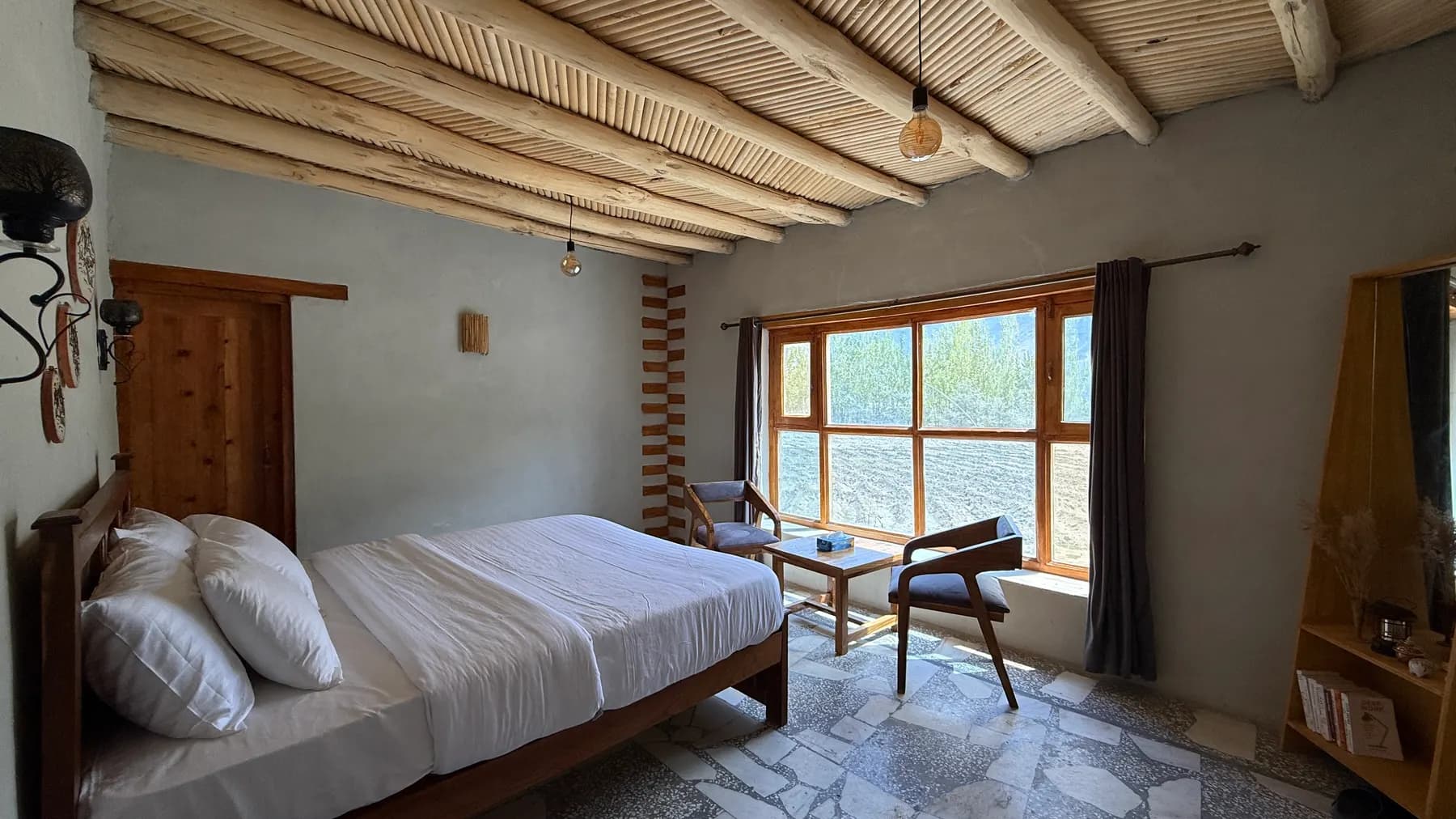 A bedroom with a poplar ceiling and a window to the fields