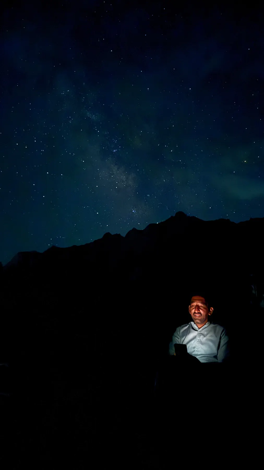 A guest sitting under the Milky Way