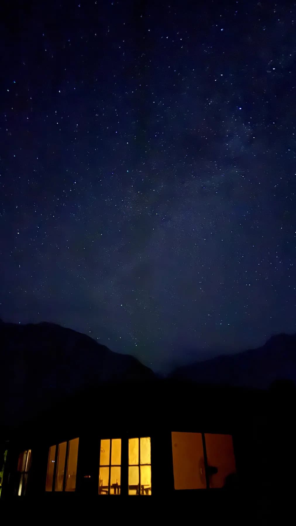 Warm windows of the lodge under the stars