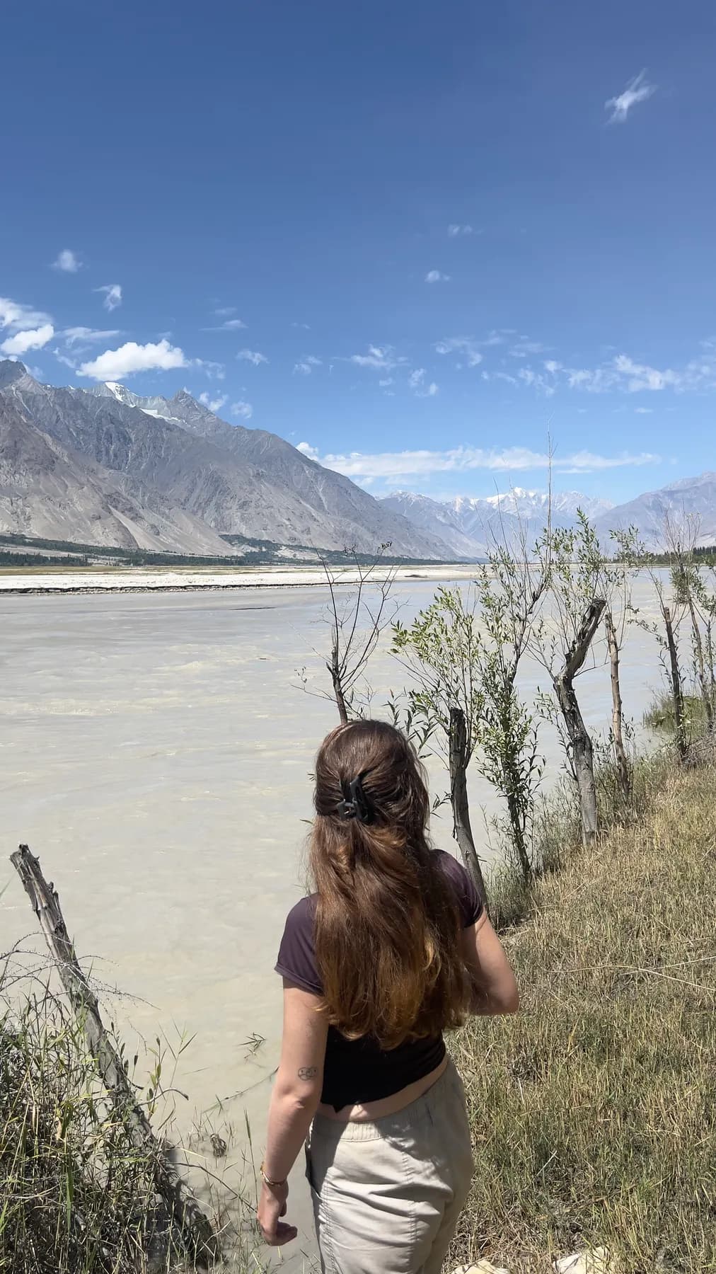 A guest looking across the pale Shigar river